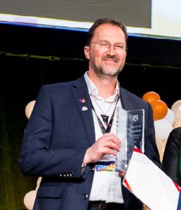 Dr Mark Nichols accepting award on behalf of OPNZ