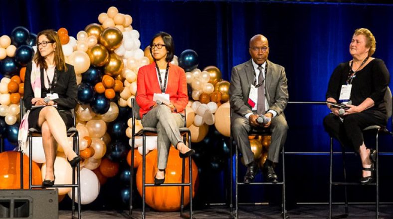 Image of 4 prominent persons during first panel discussion of PCF10