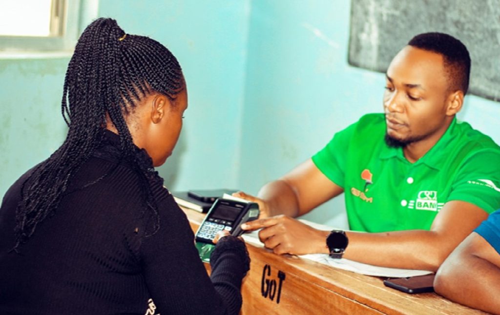A Tanzanian youth showing operation of swiping machine