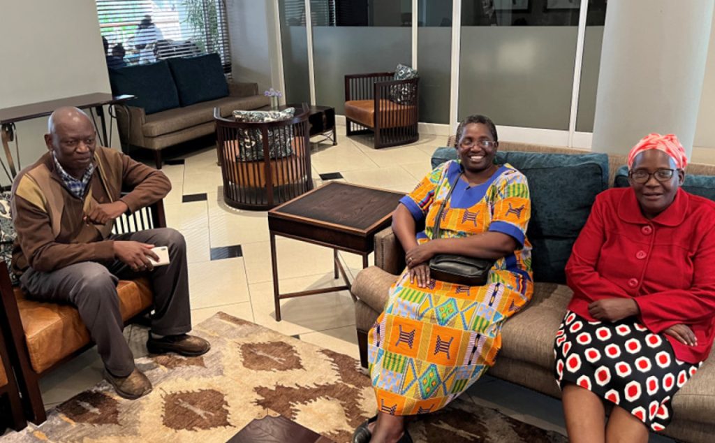 Image of 3 Zambian delegates sitting in sofa